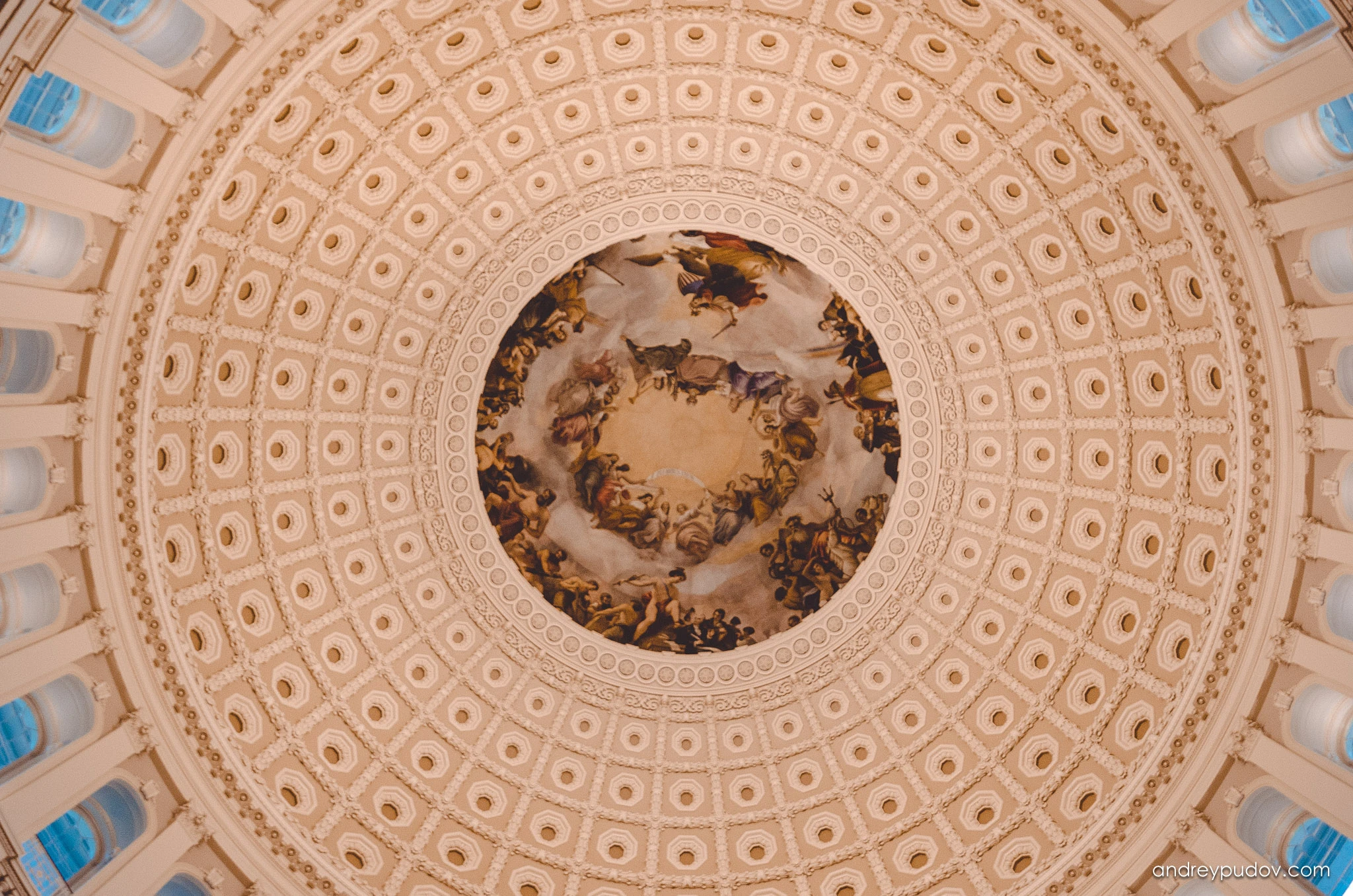 Conquering America - The Apotheosis of Washington

The Apotheosis of Washington is the fresco painted by Greek-Italian artist Constantino Brumidi in 1865 and visible through the oculus of the dome in the rotunda of the United States Capitol Building. The fresco is suspended 55 meters above the rotunda floor and covers an area of 433.3 square meters. The figures painted are up to 4.6 meters tall and are visible from the floor below. The dome was completed in 1863, and Brumidi painted it over the course of 11 months at the end of the Civil War. He was paid $40,000 ($676,261 in today's funds) for the fresco.

Brumidi had worked for three years in the Vatican under Pope Gregory XVI, and served several aristocrats as an artist for palaces and villas, including the prince Torlonia. He immigrated to the United States in 1852, and spent much of the last 25 years of his life working in the Capitol. In addition to The Apotheosis of Washington he designed the Brumidi Corridors.